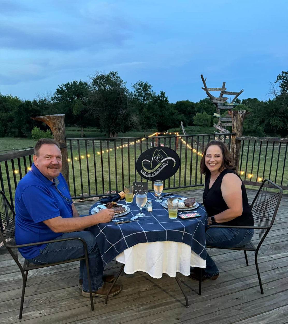 Couple enjoying anniversary dinner on the ranch deck