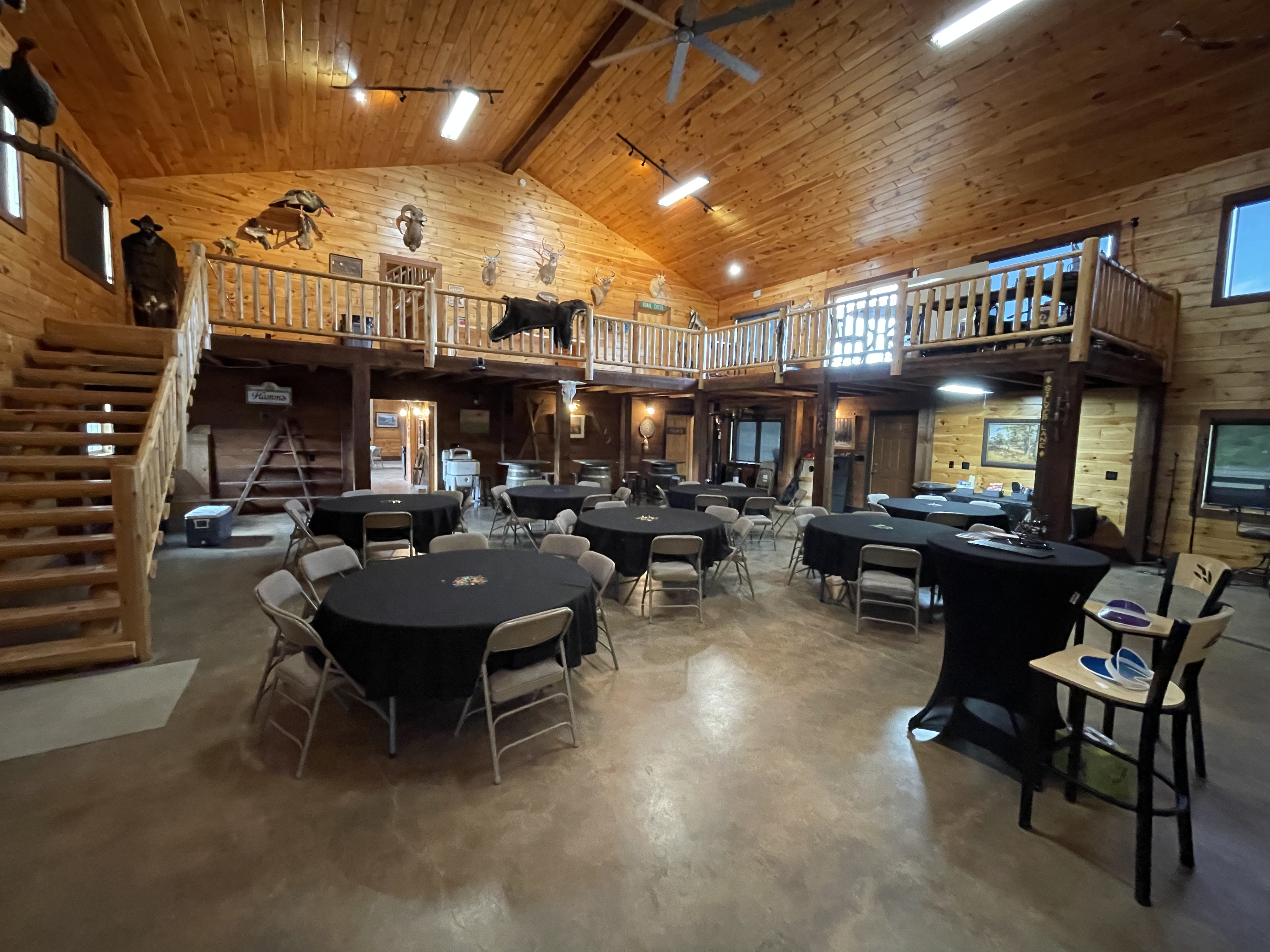 Lodge great room with loft and log beams